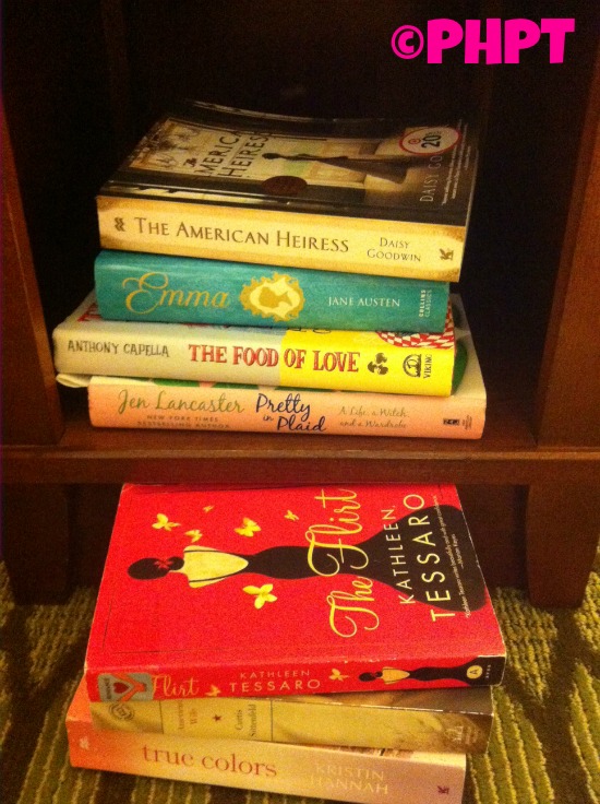 {books waiting to be read in my night stand cubby hole}